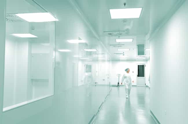 Modern bright factory interior with working people in motion