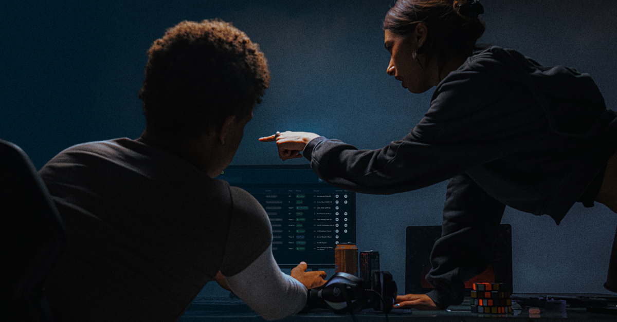 Two people look at a computer screen together